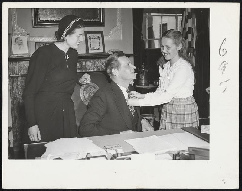 Tobin Womenfolk Give the Governor Help-Gov. Tobin, about to go before the Legislature with his annual message, is given a checkup at his desk by his eldest child, Helen Louise, with Mrs. Tobin looking on happily.