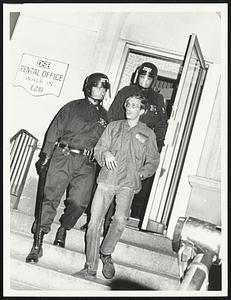 Student found by Boston TPF men on roof of 128 Hemingway St. is escorted away from the building.