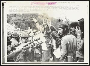 Power From the Barrel of a Gun -- A group of anti-war demonstrators at Fort Dix, New Jersey, Saturday confront military police whose bayonets have been spiked with anti-war literature. The confrontation occurred when about 3,000 protestors tore down a wire fence and entered post grounds. State police dispersed the crowd with tear gas.