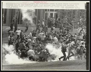 Tear gas disperses crowd on Kent State University Commons 5/4.It was reported that four persons were killed and another 15 were wounded when National Guardsmen fired into crowd when demonstrators hurled rocks.