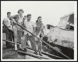 Boat Launching, post-hurricane style, is attempted by these young people near the Charles River Yacht Club. Left to right (foreground) Elinore Veilleux, Manvel Almeida and Marilyn Ernest, all of Cambridge.