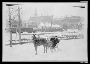 Woman & man in one horse sleigh, North Ave.