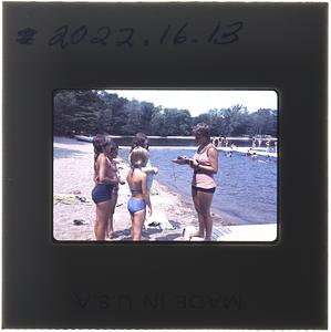 Horizons for Youth Kiddie Kamp campers standing on the beach of Lake Massapoag with a counselor