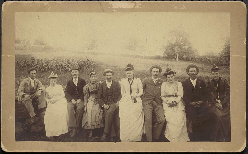 Group of couples in field, ca. August