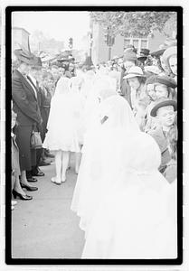 A group of children coming out of a church after their first Communion