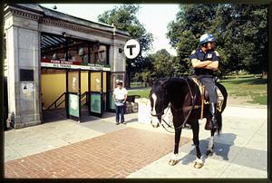 Boston - Boston Common: A mounted patrol officer waits at the entrance of the Park St. MBTA station. 1982