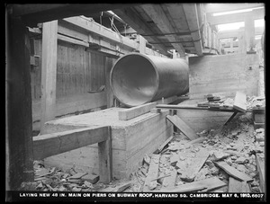 Distribution Department, Low Service Pipe Lines, laying new 48-inch main on piers on subway roof, Harvard Square, Cambridge, Mass., May 6, 1910