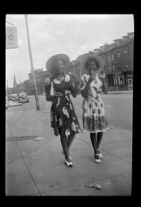 Constance and a woman walk down the street