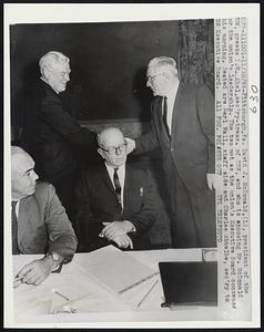 David J. McDonald, (L), president of the USW, greets I.W. Abel, sec'ry-treas. of USW, and who is opposing Mr. McDonald for the union's leadership, The two met as the union's Executive Board convened this morning. Seated are Earl Wall, staff aide and Charles Abbelbe, sec'ry to USW Executive Board.