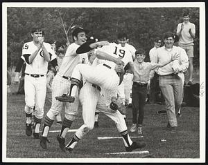 Steve Swanson awaits throw in first inning. At right, Lynch is congratulated by teammates. Woburn's 4-2 win gave both teams 12-4 records.