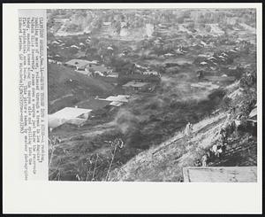 Canyon Turned Into a River--A rushing, tumbling mass of water, released through a break in Los Angeles Baldwin Hills Reservoir, races down a canyon just below the reservoir today, smashing homes along the canyon side and spilling into the flat residential area below. This picture taken by amateur photographer Richard Levine.