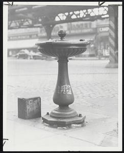 Old Drinking Fountain where thousands of children-and adults-have quenched their thirst through the years stands in solitary invitation underneath an elevated rampart of Boston.
