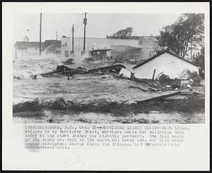 Hurricane Lashes Coast--High tides, whippes in by Hurricane Hazel, shatters boats and buildings here today as the storm lashes the Atlantic seaboard. The full brunt of the storm was felt to the south but heavy seas and high water caused widespread damage along its fringes.