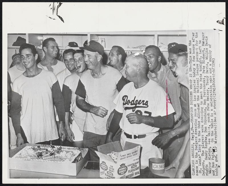 Champion Dodgers Whoop It Up--This was the scene in the Dodgers dressing room at Los Angeles today a few hours after St. Louis’ loss to the Cubs clinched the National League pennant for the Dodgers. The players were dressing to meet the Mets tonight. Left to right: Sandy Koufax, Don Drysdale, Ron Perranoski, Pete Richert, Manager Walter Alston, Lee Walls, coach Pete Reiser, Tommy Davis, Willie Davis and Ron Fairly. On the table is a celebration cake and a supply of bubble gum.