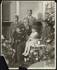 Blossom time at Boston City Hall. In front are Mayor Malcolm E. Nichols and his three children: Dexter, 6, at his right; Marjorie, 3, "the first lady" of the city in his lap, and Clark, 8. In back are Nathaniel F. P. Nichols, Jr., and Malcolm J. Nichols, nephews