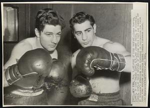 Weapons of Ring Warfare -- Bobby Ruffin, (left), of Long Island City, N.Y., and Johnny Greco, of Montreal, Canada, display their weapons of offense after they had worked out at Stillman's Gymnasium here yesterday in preparation for their third ring meeting at Madison Square Garden tomorrow night.