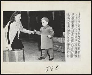 Boy, 5, Walks on Artificial Legs- One of the youngest double amputees in memory of hospital officials here, five-year-old Jackie Blewitt shows his mother, Mrs. John Blewitt, how well he can walk as he leaves Crippled Children's Hospital yesterday. Born with deformed lower legs and feet, Jackie could only crawl on his knees. Earlier this year a double amputation was performed and Jackie was fitted with artificial legs so designed that they can be adjusted to "grow" with him for next four of five years