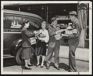 Swapping Books-Scene here yesterday, as the Merchant Marine Library Association and the Russian War Relief exchanged books, to the advantage of all concerned. The Russian group acquired English classics for the looted library shelves of Russia, in exchange for popular fiction to lighten the hours of American merchant seamen. The "traders," left to right-Miss Charlotte Kaizer, Mrs. Tamara McIntyre, Brooks Jenkins, librarian of the association, and Prof. Theodore Spencer, chairman of the "Books for Russia" campaign