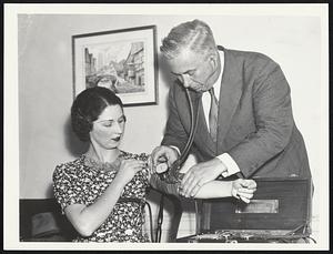 Dr. William Moulton Marston applies the Marston Lie Detector Test to a (Edna Cushing) pretty subject.