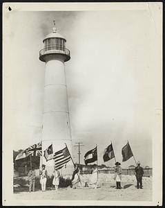 Rome May be the City of Seven Hills, but Biloxi is the City of Seven Flags. Photo Shows: Seven flag-bearer at Biloxi, Mississippi, representing the seven different governments which have ruled this city. Biloxi was the first capital of the Louisiana Province or French Dominions, and was discovered by Iberville in 1699. The flags which have flown over Biloxi in the past are, left to right: Confederate States, British, Mississippi Magnolia, United States, Mississippi State, Spanish and French.