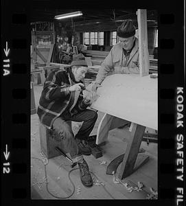 Ralph Johnson and Pert Lowell working in boat shop