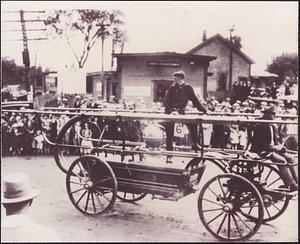 Warren hand tub on parade, with Harold Olsen on top, horse-drawn