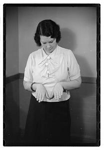 A woman looking down at her hands