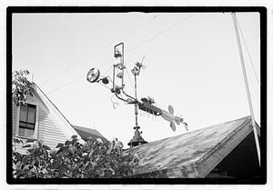 An elaborate device on roof, possibly a weather vane