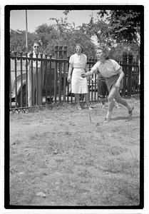 Two young women playing horseshoes