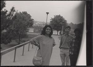 Three people posing and smiling outside