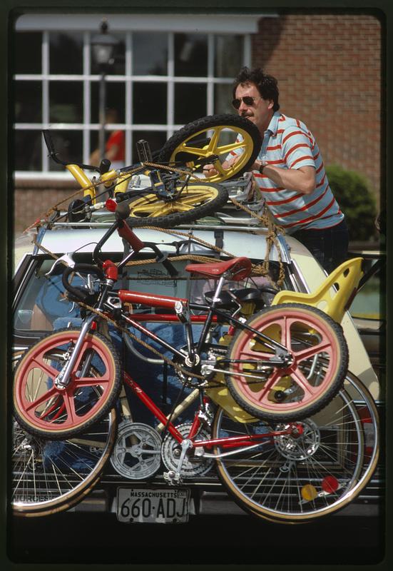 Father loads up children's' bicycles, Gloucester