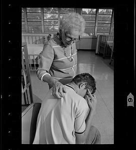 Retired volunteer "foster grandmother" works with retarded child at the Ladd School, Exeter, Rhode Island