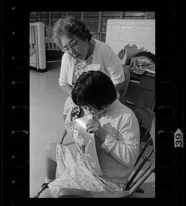 Retired volunteer "foster grandmother" works with retarded child at the Ladd School, Exeter, Rhode Island