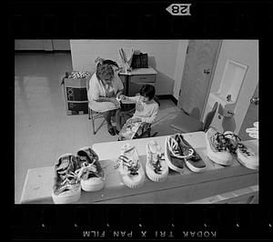 Retired volunteer "foster grandmother" works with retarded child at the Ladd School, Exeter, Rhode Island