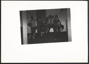 Group of young people sitting on a table and laughing
