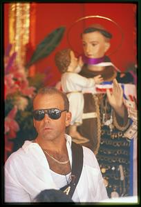 Boston - N. End 2002 - A man stands next to the statue of St. Anthony during the annual Feast