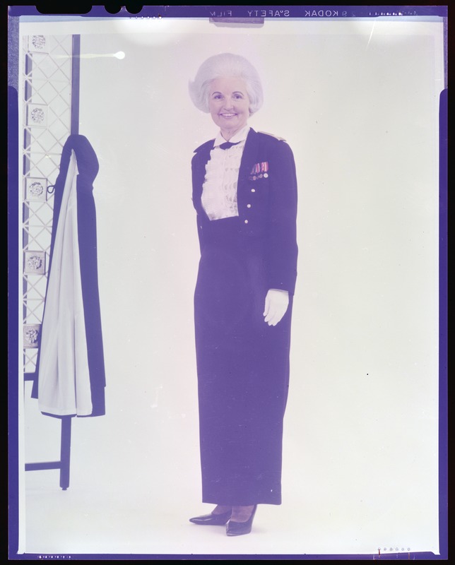 Women's evening mess uniform, black jacket with long skirt, officer (cape in background)