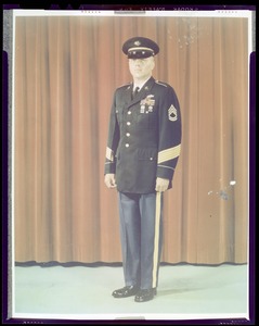 Army blue uniform for enlisted men with service cap, five gold colored service, stripes on sleeve indicate 15 years service