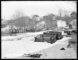 Sudbury Department, dump cars at Whitehall Dam, at road just below Dam, from the west on scow back of dredge, Woodville, Hopkinton, Mass., Feb. 17, 1898