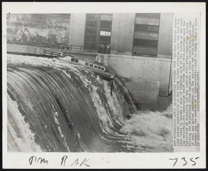 Minneapolis – Houseboat Plunges Over Dam – This 40-foot houseboat poised momentarily on the brink before plunging over the Ford dam here today to become a mass of kindling wood at the bottom of the roaring waterfall. The unoccupied craft broke loose from moorings near the University of Minnesota and was carried five miles downstream before hitting the Mississippi river dam, where a barge laden with 1,200 tons of coal was halted yesterday – at the opposite end from this picture. Workers jam the doorway of a hydroelectric plant to watch today’s show.