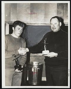 Rebel Ryan (left), who placed first in all three events at the Junior Alpine Championships at Sugar Loaf Mountain over the weekend, is congratulated by race chairman Harvey Boyington. Ryan, 18-year-old from Rutland, Vt., also won a place on the Eastern team which is slated for competition at Squaw Valley this month.