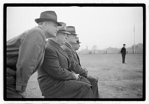 Boston Park Department Commissioner William Long seated next to three other men, an unidentified man looking over his shoulder