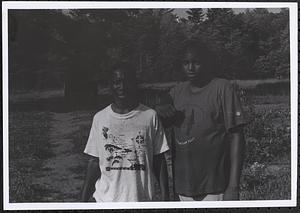 Two young men standing in a park