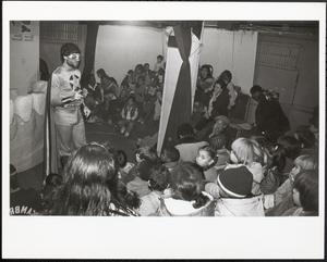 Costumed performer speaking to group of children