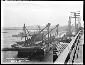 Distribution Department, Low Service Pipe Lines, Section 5, scow, pile driver and dredge, station 338+, from the north, on the draw of the Wellington Bridge, Somerville, Mass., Sep. 8, 1897