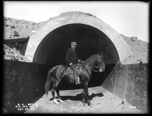 Wachusett Aqueduct, section of aqueduct, with Mr. Silvio Casparis on horseback; Silvio A. Casparis (1849-1921) was a contractor from Columbus, Ohio (Contract Nos. 19, 20, 21, 22, 24, 25), Section 5, station 204, Berlin, Mass., Oct. 23, 1897