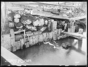 Distribution Department, Low Service Pipe Lines, Malden River crossing, Section 6, station 424, Medford Street, leakage through south side of cofferdam at west end of bridge, from northeast, Malden, Mass., Nov. 22, 1897