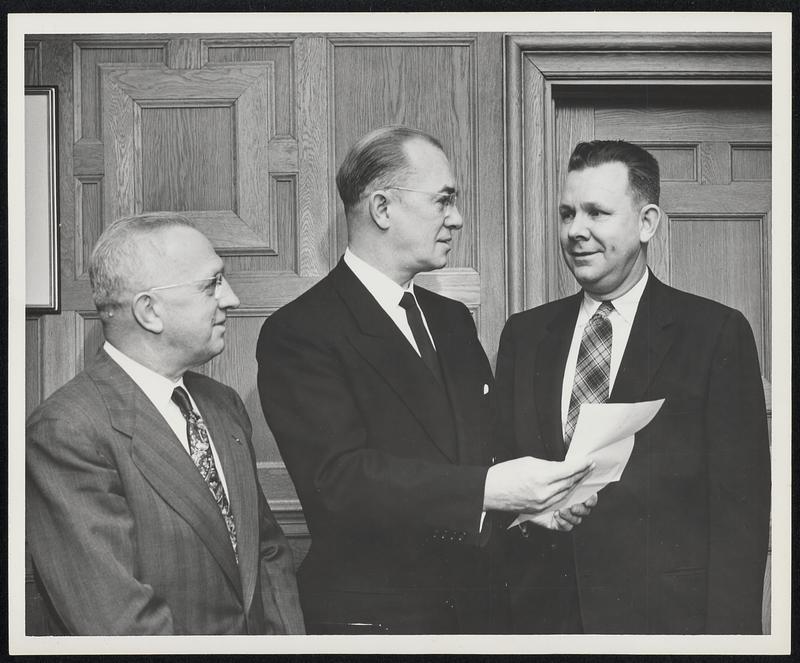 President Harold C. Case of Boston University, reads letter informing him that Boston University has been selected to receive a gift of $5000 under a new educational aid program of the Westinghouse Electric Corporation. Looking on are A.E. Lambert, (right) Agency and Construction Area Manager of Westinghouse's Boston District, who presented the letter of notification, and Prof. Norman H. Abbott, Director of the University's Placement Service. Westinghouse is presenting gifts to a number of colleges and universities throughout the nation to help defray their current operating expenses.