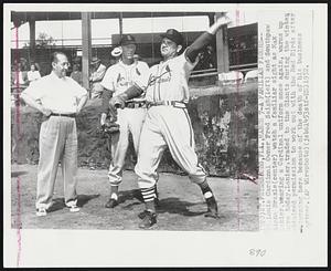 A Familiar Figure-- St. Louis Cardinal Owner Fred Saigh (left) and Southpaw Alpha Brazle (center) watch a familiar sight as Max Lanier, wearing a Cardinal uniform once again, warms up here today. Lanier, traded to the Giants during the winter, obtained permission to work out with the Red Birds after returning here because of the death of his business partner.