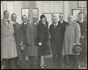 German industrialists, visiting Boston, were greeted by Mayor Nichols at City Hall. They are, left to right, H. Werther, H. Nikolaus, A. Gayler, M. Tugenhadt, Mrs. Tugenhadt, Mayor Nichols, Kurt Knodt, Carl Hangleiter, and Daniel J. Harkins of the Hamburg-American steamship line.